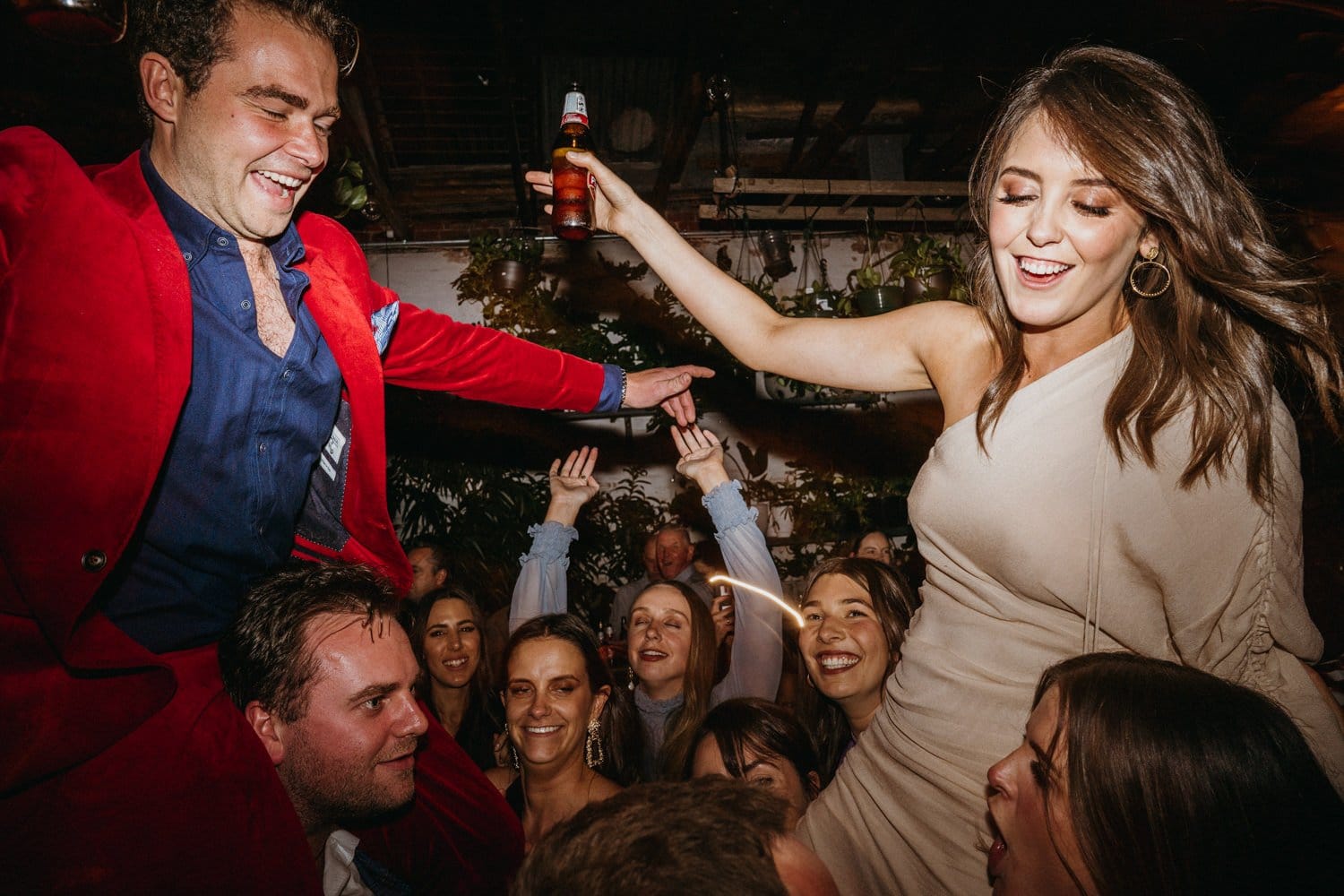 Bride And Groom Riding On Guests' Shoulders at Glasshaus Wedding Reception
