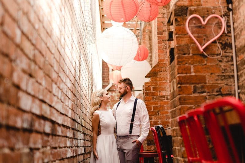 Bride and Groom Pose at Brunswick Mess Hall Outside Photographed by TOne Image